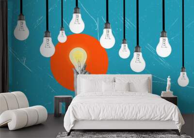 Creativity and New Ideas in Business. Artistic Collage. A hand with a glowing light bulb Wall mural