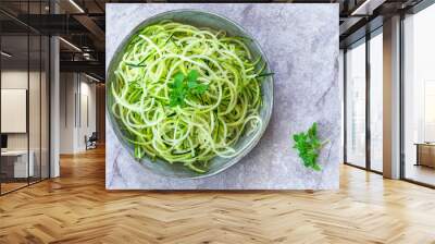 Courgette spaghetti - shredded zucchini on a plate - top view Wall mural