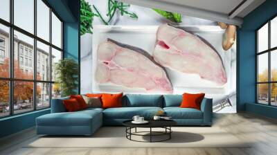 Two raw halibut steaks garnished with samphire - top view Wall mural