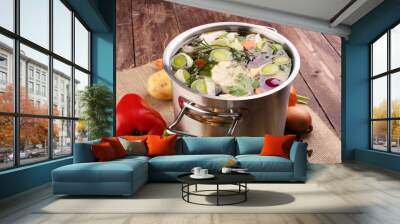 Broth with carrots, onions various fresh vegetables in a pot - c Wall mural