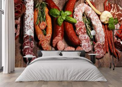 cold meat assortment with delicious salami and  fresh herbs . Variety of meat products including coppa and sausages Wall mural