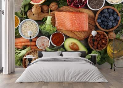 Healthy food clean eating selection: fish, fruit, vegetable, cereal, leaf vegetable on rustic background Wall mural