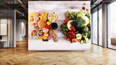 healthy or unhealthy food. Concept photo of healthy and unhealthy food. Fruits and vegetables vs donuts,sweets and burgers Wall mural