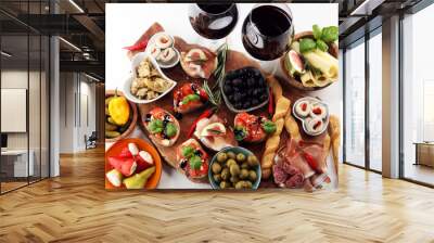 Italian antipasti wine snacks set. Cheese variety, Mediterranean olives, pickles, Prosciutto di Parma, tomatoes, artichokes and wine in glasses Wall mural