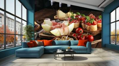 Italian antipasti wine snacks set. Cheese variety, Mediterranean olives, seafood salad, Prosciutto di Parma, tomatoes, anchovy and wine in glasses Wall mural