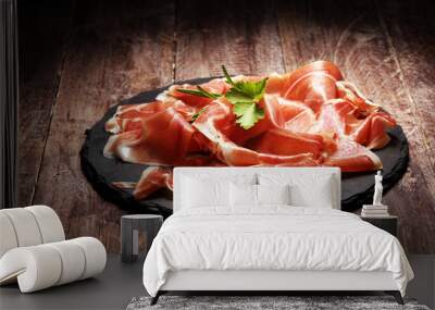 Italian prosciutto crudo or jamon with rosemary. Raw ham on wooden board Wall mural