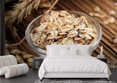 Oatmeal and oatmeal on the wooden background. Healthy eating concept Wall mural