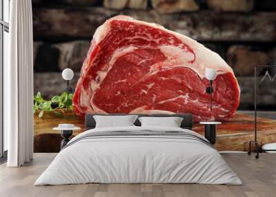 Raw fresh meat Ribeye Steak, seasoning and meat fork on dark background Wall mural