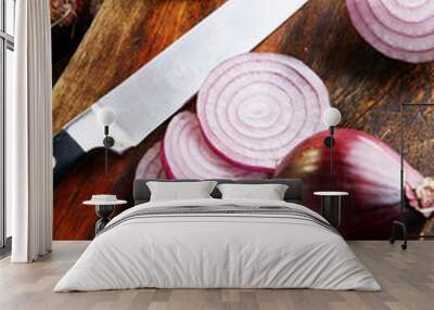 Red onions circles and red onions on board against wooden backgr Wall mural