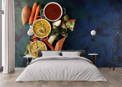 Set of soups from worldwide cuisines, healthy food. Broth with noodles, beef soup and broth with marrow dumplings. All soups with healthy vegetables on table Wall mural