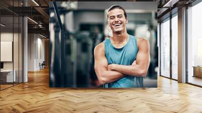 Fitness, gym and happy portrait of personal trainer man ready for workout coaching. Training, wellness and exercise coach confident with arms crossed at professional athlete health club. Wall mural