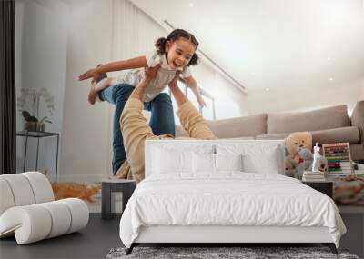 Happy family, father and girl playing in a house with freedom, bonding and enjoying quality time together. Happiness, smile and child flying in dads arms on the floor on a weekend at home in Portugal Wall mural