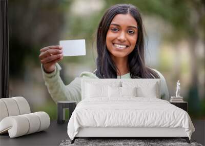 Life doesnt come with a free pass but theres always student cards. Shot of a young woman holding a blank card outside at college. Wall mural