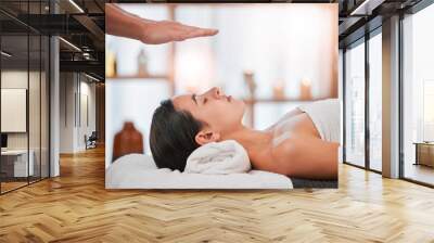 Reiki, energy and light with woman in spa for alternative medicine, spiritual and faith wellness. Health, relax and holistic therapy with hands of massage therapist for healing, peace and focus Wall mural