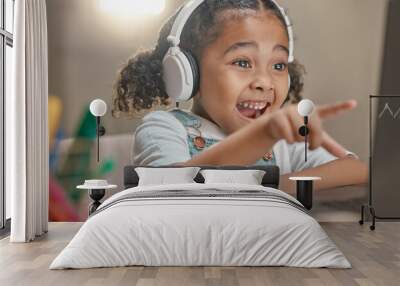 Student, education and remote learning with an excited black girl in her home using a laptop and headphones. Computer, study and elearning with a female child in her house for studying or development Wall mural