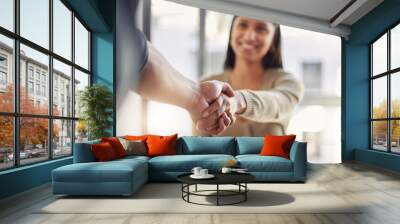 Handshake, partnership and agreement with a business woman and colleague in an office for a meeting. Thank you, collaboration and trust with people shaking hands together in a corporate workplace Wall mural