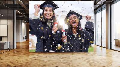 Queue the celebrations. Cropped portrait of two attractive young female students celebrating on graduation day. Wall mural