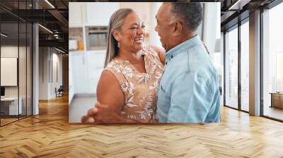 Senior couple dance in kitchen with celebration for retirement, real estate or happy marriage. Elderly pension people dancing to music with love, care and wellness in their house or home together Wall mural