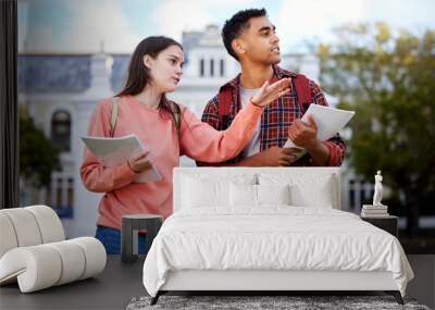 Thats where everyone hangs out. Shot of a young woman showing a fellow student around. Wall mural