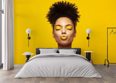 Enjoyed African American Fashion Model portrait . Satisfied Brunette young woman with afro hair style and closed eyes show kiss,creative yellow make up, lips and eyeshadows on colorful background. Wall mural