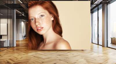 Freckles young Beauty girl portrait. Attractive model with beautiful natural ginger red hair Wall mural