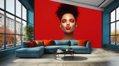 Kiss lips. Share love.Valentine Day. African makeup face. Satisfied Brunette young woman with afro hair style against colorful background. Wall mural