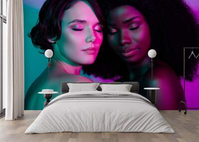 Portrait of two attractive dreamy sweet desirable women bonding isolated over vivid violet purple green gradient neon color background Wall mural