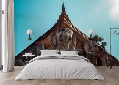 Travel to Asia and holidays concept. Elephant sculptures around the stupa. Wat Chang Lom in the historical temples in Sukhothai, the ancient city with buddhist heritage in the north east in Thailand. Wall mural