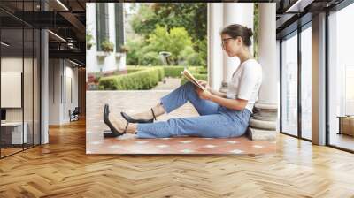 woman reading literature in a garden Wall mural