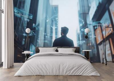 A man in a suit stands in the middle of a city street, looking up at the skyscrapers, with futuristic data and technology visuals floating around him. Wall mural