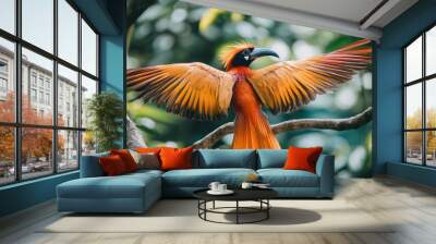 A vibrant orange and red bird with a black beak perches on a branch with its wings spread wide. Wall mural