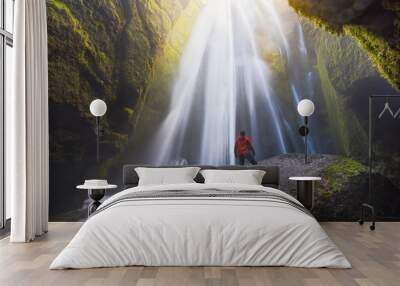 man looking at the gljufrabui waterfall inside a cave in iceland Wall mural