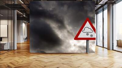 Photo realistic 'snow warning' sign, against a stormy sky Wall mural