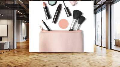 Aerial view of make up products spilling out of a pastel pink cosmetics bag, isolated on a white background Wall mural