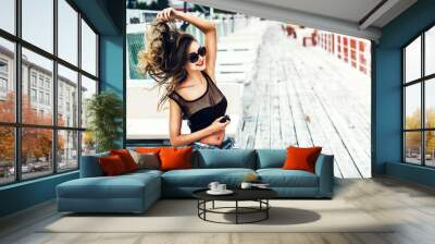 Brunette girl in black swimsuit relaxing outdoor Wall mural