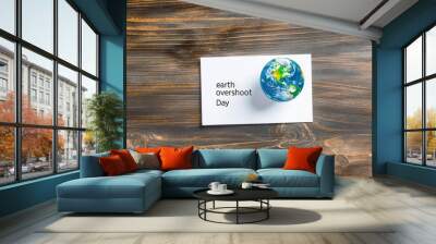 earth overshoot day text on wooden background with globe Wall mural