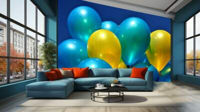 blue and yellow metallic balloons in the city festival against deep blue sky  Wall mural