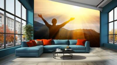 Man thanks God on  mountain. Wall mural