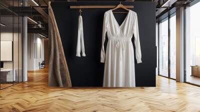 white dress hanging on a wooden hanger against a dark black wall created with generative ai Wall mural