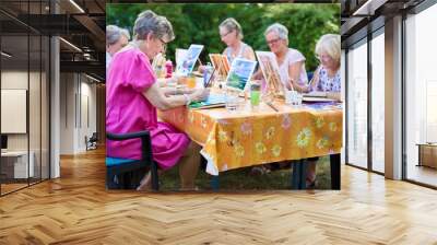 Senior women taking art lessons. Wall mural