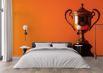 classic silver trophy on bright orange background for championship and victory concepts, with copy space for text Wall mural