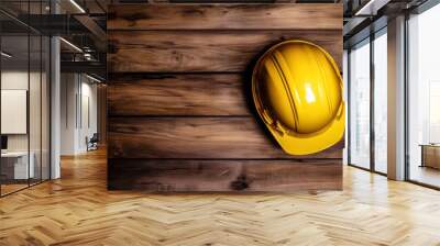 yellow safety helmet on rustic wooden background, construction concept Wall mural