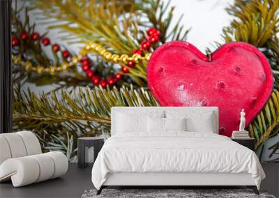 Red heart and beads lie on a spruce branch Wall mural