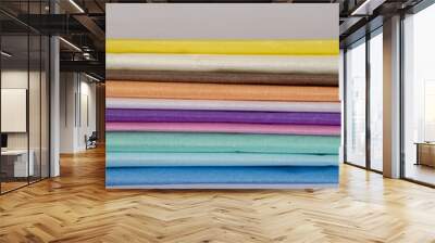 The end of multi-colored paper Quietly stacked on a gray background Wall mural