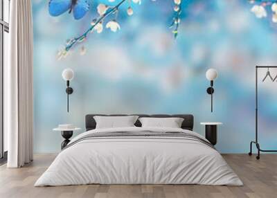 Cherry blossoms over blue nature background. Spring flowers. Spring background with bokeh. Butterfly. Wall mural