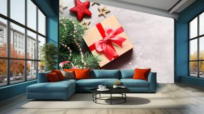 Christmas background, green pine branches, cones and gift box on grey background. Creative composition with copy space, top view. New Year's holiday, christmas. Wall mural