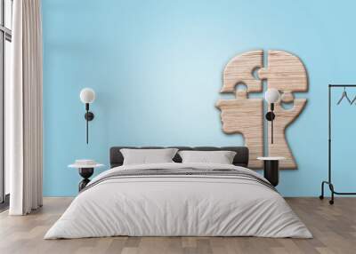 Human head silhouette with a jigsaw piece cut out on the blue background, mental health concept. Wall mural