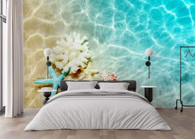 Starfish and seashell on the summer beach in sea water. Summer background. Summer time. Wall mural