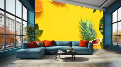 Summer background. Palm leaf, pineapple in sunglasses, starfish and seashell on yellow background. Wall mural