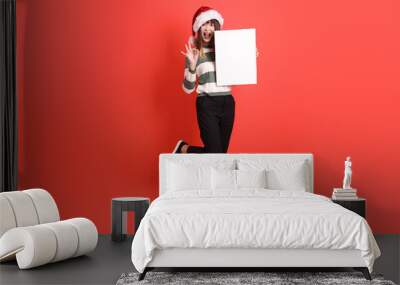 Woman wearing Santa hat Wall mural